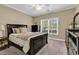 Cozy bedroom featuring plush carpeting, a ceiling fan, and a large window overlooking the outdoors at 904 Moultrie Circle, Myrtle Beach, SC 29588