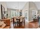 Bright dining room featuring hardwood floors, a modern chandelier, and a large window providing ample natural light at 904 Moultrie Circle, Myrtle Beach, SC 29588