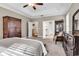 Spacious primary bedroom features a tray ceiling and a doorway to an ensuite bathroom at 904 Moultrie Circle, Myrtle Beach, SC 29588
