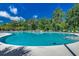 A large community pool surrounded by trees and lounge chairs and sign reading 'Grande Dunes Plantation' at 904 Moultrie Circle, Myrtle Beach, SC 29588