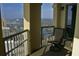 Inviting balcony with seating, offering stunning views of the cityscape and lake at 9994 Beach Club Dr. # 2402, Myrtle Beach, SC 29572