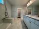 Bathroom featuring double sink vanity, marble tile flooring, and a glass enclosed shower at 1005 Lady Bird Way, North Myrtle Beach, SC 29582