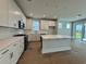 Modern kitchen features white cabinets, island, stainless steel appliances, and breakfast bar at 1005 Lady Bird Way, North Myrtle Beach, SC 29582