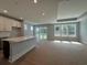 Spacious living room with large windows, recessed lighting, and adjacent kitchen area at 1005 Lady Bird Way, North Myrtle Beach, SC 29582