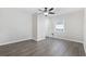 The bedroom features wood laminate flooring, a ceiling fan, and bright windows at 1022 Waccamaw Dr., Conway, SC 29526