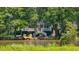 Charming home on the river with a large porch, dock, and mature trees at 1022 Waccamaw Dr., Conway, SC 29526