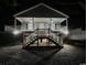 Night view of elevated beach house with inviting porch and stairs, showcasing outdoor lighting at 1022 Waccamaw Dr., Conway, SC 29526
