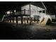 Wide angle, dark night view of elevated beach house on stilts showing support beams and stairs at 1022 Waccamaw Dr., Conway, SC 29526