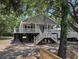 Charming raised beach house with gray siding, white railings, and inviting front porch at 1022 Waccamaw Dr., Conway, SC 29526