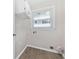 Laundry room with wooden floors, upper storage cabinet, and a bright window at 1022 Waccamaw Dr., Conway, SC 29526
