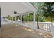 Large covered porch with a beautiful river view, ceiling fans, and white railings at 1022 Waccamaw Dr., Conway, SC 29526