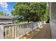 Outdoor porch with wood floor and a white railing showcasing the backyard and trees at 1022 Waccamaw Dr., Conway, SC 29526