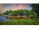 Scenic waterfront view with lush greenery and a boat traveling along the river at 1022 Waccamaw Dr., Conway, SC 29526