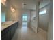 Modern bathroom with double vanity, granite countertops, and a glass-enclosed shower with gray tiling at 1117 Oxeye St., North Myrtle Beach, SC 29582
