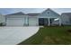 Charming one-story home with a two-car garage, and light blue siding and a well manicured lawn at 1117 Oxeye St., North Myrtle Beach, SC 29582