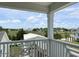 Balcony view showcasing the marsh, nearby neighborhood, and bright blue skies at 135A Sunset Dr., Murrells Inlet, SC 29576