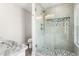 Modern glass-enclosed shower featuring a stone floor, decorative tile, and sleek fixtures at 135A Sunset Dr., Murrells Inlet, SC 29576