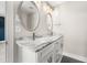Bathroom vanity with a marble countertop, dual sinks, and decorative mirrors at 135A Sunset Dr., Murrells Inlet, SC 29576
