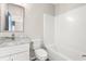 Modern bathroom with a marble countertop vanity, toilet, and a white tiled bathtub shower at 135A Sunset Dr., Murrells Inlet, SC 29576