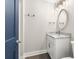 A well-lit bathroom featuring a blue door, a marble vanity top, and a framed mirror at 135A Sunset Dr., Murrells Inlet, SC 29576
