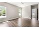 Bright, spacious bedroom featuring hardwood floors, a ceiling fan, and natural light at 135A Sunset Dr., Murrells Inlet, SC 29576