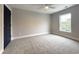 Empty bedroom with neutral walls, carpet, white trim and a window letting in sunlight at 135A Sunset Dr., Murrells Inlet, SC 29576