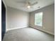 This bedroom features plush carpet, a ceiling fan, and a window, making it a comfortable and inviting space at 135A Sunset Dr., Murrells Inlet, SC 29576