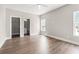 Spacious bedroom featuring hardwood floors, white trim, ceiling fan, and a bathroom ensuite at 135A Sunset Dr., Murrells Inlet, SC 29576