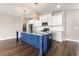 Spacious modern kitchen with stainless appliances, blue kitchen island, and white countertops at 135A Sunset Dr., Murrells Inlet, SC 29576