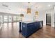 Stylish kitchen island, hardwood flooring, modern sink and stainless steel appliances, and modern lighting at 135A Sunset Dr., Murrells Inlet, SC 29576