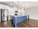 Modern kitchen featuring stainless steel appliances, white cabinets, and a blue center island with barstool seating at 135A Sunset Dr., Murrells Inlet, SC 29576