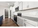 Modern kitchen featuring white cabinets, dark countertops and stainless steel appliances at 135A Sunset Dr., Murrells Inlet, SC 29576