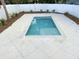The backyard showcases a private pool and a surrounding white fence and a gorgeous tile deck at 135A Sunset Dr., Murrells Inlet, SC 29576