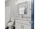 Bathroom with white vanity and countertop, matching toilet, and tiled shower-tub combination at 135B Sunset Dr., Murrells Inlet, SC 29576