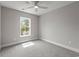 Neutral bedroom featuring a ceiling fan and sunlit window with outdoor views at 135B Sunset Dr., Murrells Inlet, SC 29576