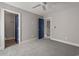 Bright bedroom with two doorways, gray carpet and a ceiling fan at 135B Sunset Dr., Murrells Inlet, SC 29576