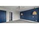Well-lit bedroom featuring an accent wall, modern lamps, and a walk-in closet at 135B Sunset Dr., Murrells Inlet, SC 29576