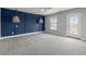 Spacious bedroom with unique accent wall, modern lighting, and balcony access at 135B Sunset Dr., Murrells Inlet, SC 29576