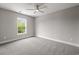 Clean, empty bedroom with gray carpet, a window, and a ceiling fan at 135B Sunset Dr., Murrells Inlet, SC 29576