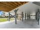 View under an elevated home highlighting the support pilings and parking area at 135B Sunset Dr., Murrells Inlet, SC 29576