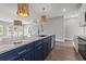 Open kitchen island features a sleek design, stainless steel appliances, and flows seamlessly into the living at 135B Sunset Dr., Murrells Inlet, SC 29576