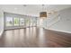 Bright living room with hardwood floors, a modern chandelier, and a staircase at 135B Sunset Dr., Murrells Inlet, SC 29576