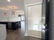 View into living room and kitchen area, featuring hardwood floors and modern pendant lighting at 135B Sunset Dr., Murrells Inlet, SC 29576
