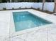 In-ground swimming pool with small deck and minimal landscaping around a white fence at 135B Sunset Dr., Murrells Inlet, SC 29576