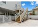Wooden staircase leading to an elevated home's deck and white fencing around the perimeter at 135B Sunset Dr., Murrells Inlet, SC 29576