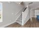 Carpeted staircase with white railing in a bright home interior with hardwood flooring at 135B Sunset Dr., Murrells Inlet, SC 29576