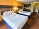 Inviting bedroom with two beds, a kitchenette, and warm, welcoming decor at 1501 S Ocean Blvd. # 1422, Myrtle Beach, SC 29577