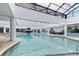 Bright indoor pool area featuring a fountain, lounging chairs, and a high vaulted ceiling with a skylight at 1501 S Ocean Blvd. # 1422, Myrtle Beach, SC 29577