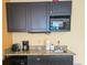 Convenient kitchenette featuring granite countertops, microwave, coffee maker, and ample cabinet space at 1501 S Ocean Blvd. # 1422, Myrtle Beach, SC 29577