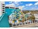 Exterior view of the waterslides, with palm trees and lounge chairs surrounding at 1501 S Ocean Blvd. # 1422, Myrtle Beach, SC 29577
